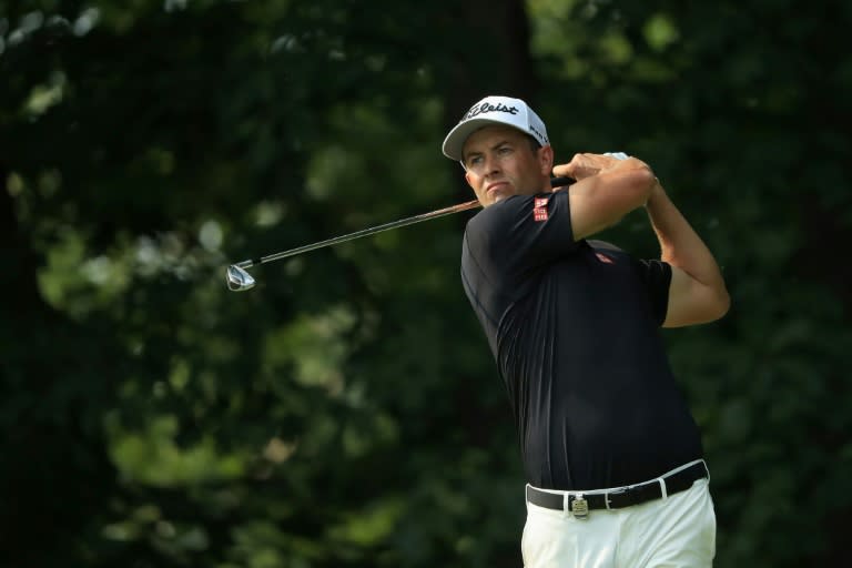 Adam Scott of Australia plays his shot from the 14th tee