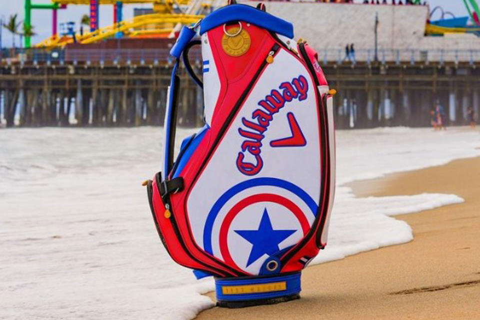 A Callaway golf bag in front of a pier