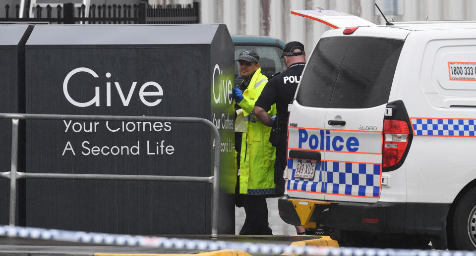 Queensland police at the scene where a body of a woman was found inside a charity bin at a Stockland shopping centre at Burleigh Heads on the Gold Coast.