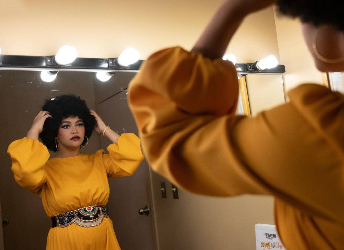 Alyssa Byers a native of Wichita, Kansas, adjusts her wig in the dressing room before a performance where she appears on stage as one of the three members of “The Sweet Inspirations.”