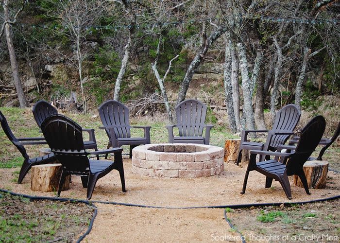 <p>For a fire pit the whole family can enjoy, use granite, sand, or pea gravel to make a wide circle around the pit. It's safer, and when surrounded by adirondack chairs, it creates a "room" in your yard.</p><p><strong>Get the tutorial at <a href="https://www.scatteredthoughtsofacraftymom.com/how-to-make-a-fire-pit/" rel="nofollow noopener" target="_blank" data-ylk="slk:Scattered Thoughts of a Crafty Mom;elm:context_link;itc:0;sec:content-canvas" class="link ">Scattered Thoughts of a Crafty Mom</a>.</strong></p><p><a class="link " href="https://go.redirectingat.com?id=74968X1596630&url=https%3A%2F%2Fwww.wayfair.com%2Foutdoor%2Fpdp%2Fpolywood-country-living-adirondack-chair-ocgv1802.html&sref=https%3A%2F%2Fwww.countryliving.com%2Fdiy-crafts%2Fg31966151%2Foutdoor-fireplace-ideas%2F" rel="nofollow noopener" target="_blank" data-ylk="slk:SHOP ADIRONDACK CHAIRS;elm:context_link;itc:0;sec:content-canvas">SHOP ADIRONDACK CHAIRS</a><br> </p>