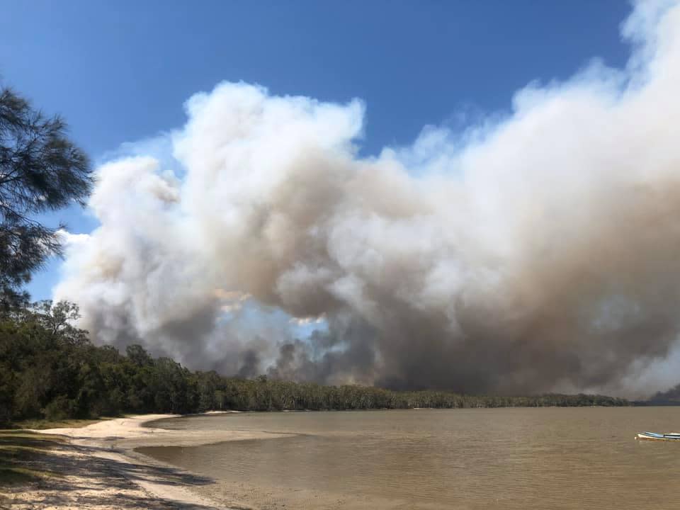 Smoke from Sunshine Coast bushfires as emergency services order the evacuation of several communities.