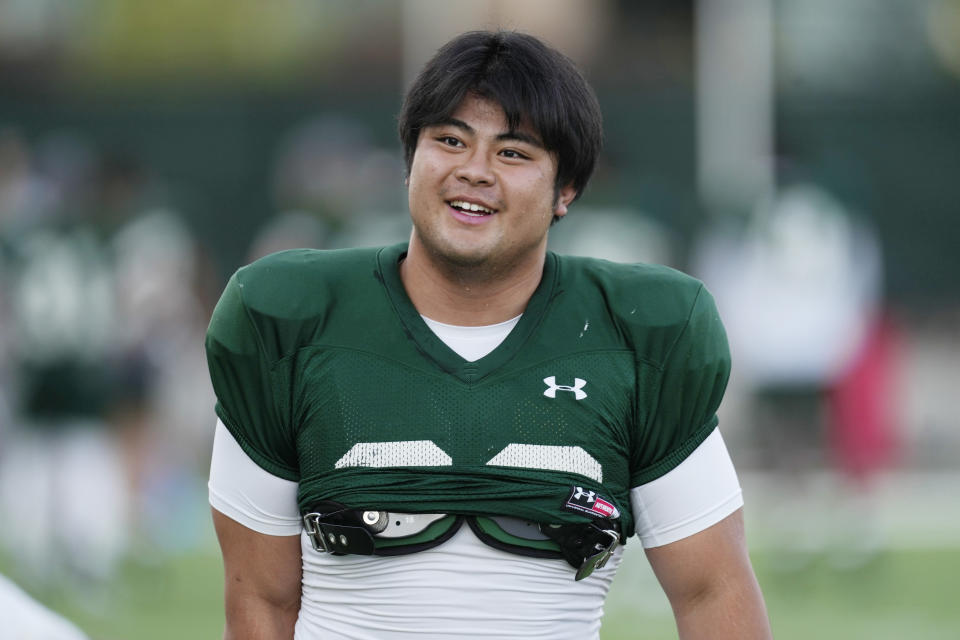 Colorado State defensive lineman Hidetora Hanada warms up during the team's NCAA college football practice on the university's campus Tuesday, Aug. 8, 2023, in Fort Collins, Colo. Hanada was a highly ranked sumo wrestler in Japan. He decided he wanted to try something different so he arrived at Colorado State where he is learning to be a defensive lineman for the Rams. (AP Photo/David Zalubowski)