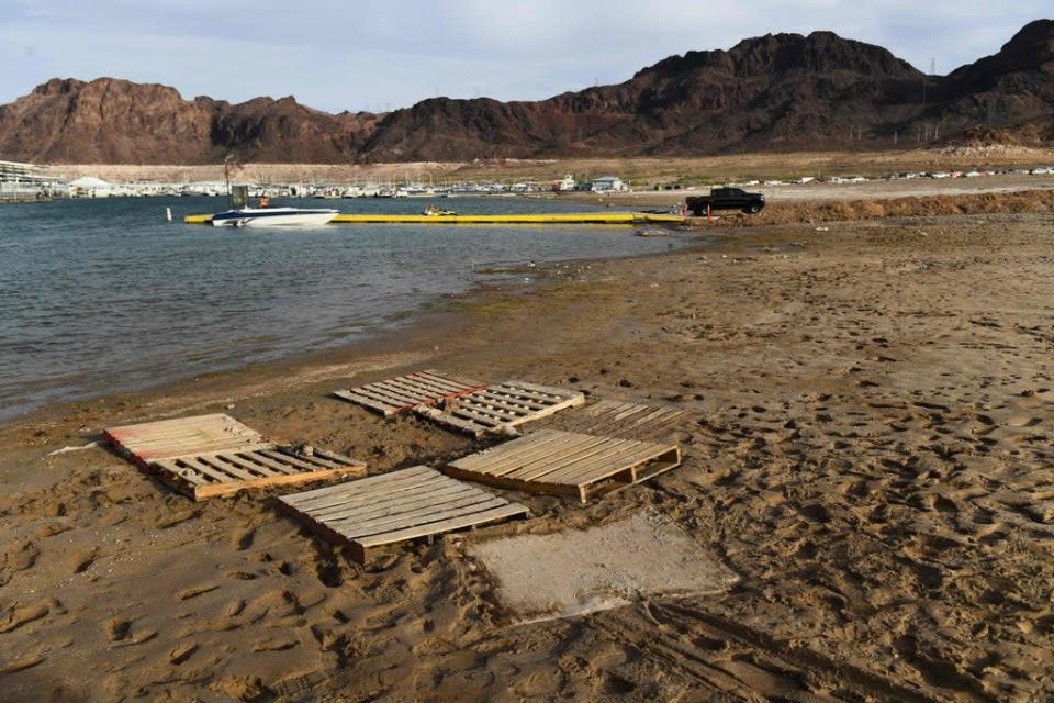 Pallets note where human remains were recently found on the shore of Lake Mead as the water level drops to unprecedented lows, a result of years-long drought (AFP via Getty Images)