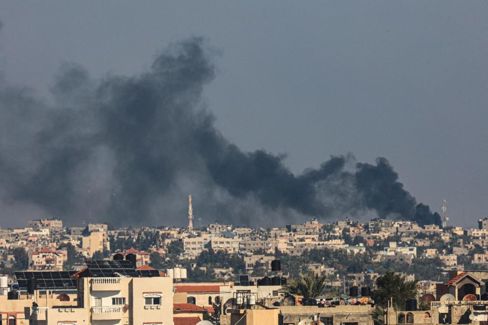 A picture taken from Rafah shows smoke billowing over Khan Yunis in the southern Gaza Strip following Israeli bombardment on Friday amid continuing battles between Israel and the Palestinian militant group Hamas.