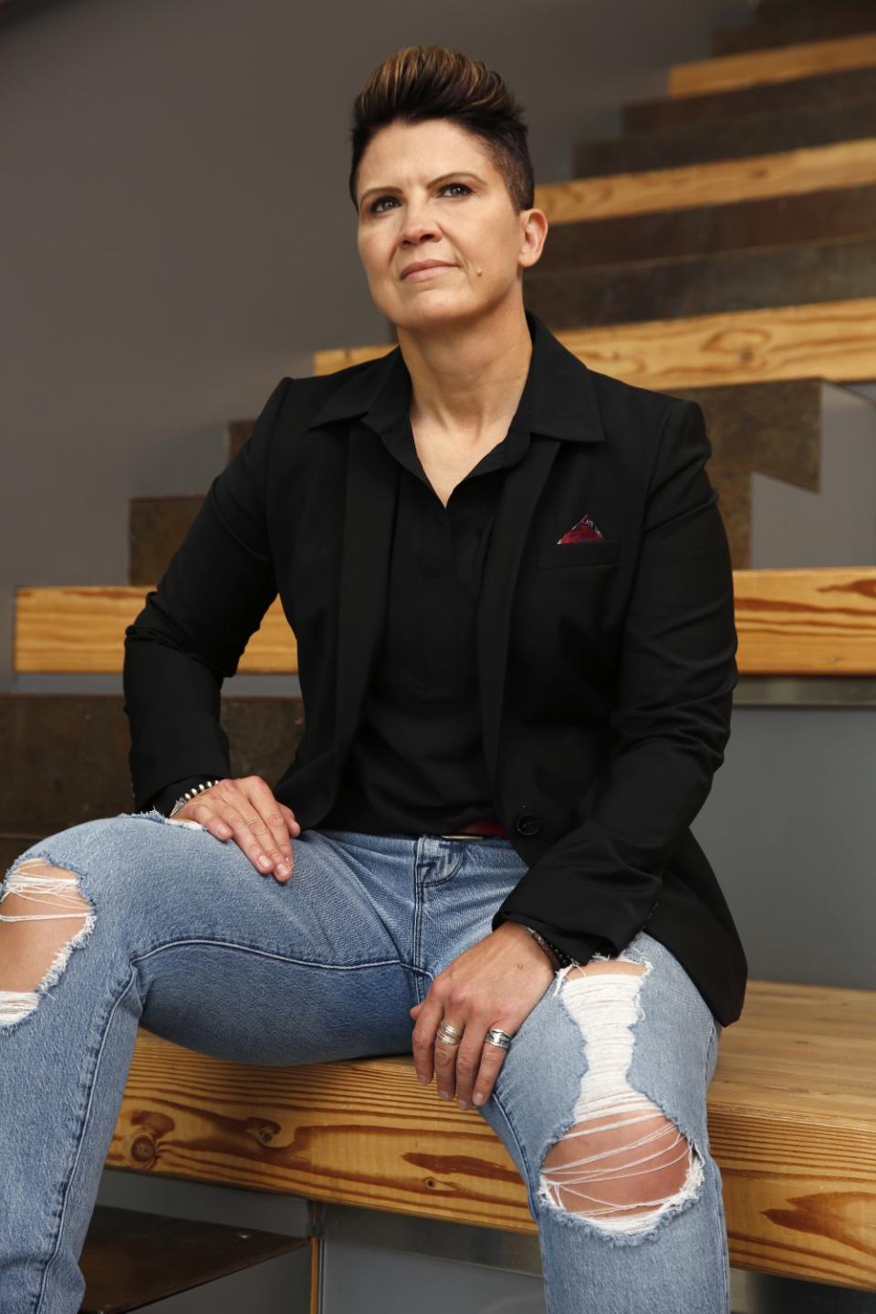 A portrait of a woman sitting on stairs.