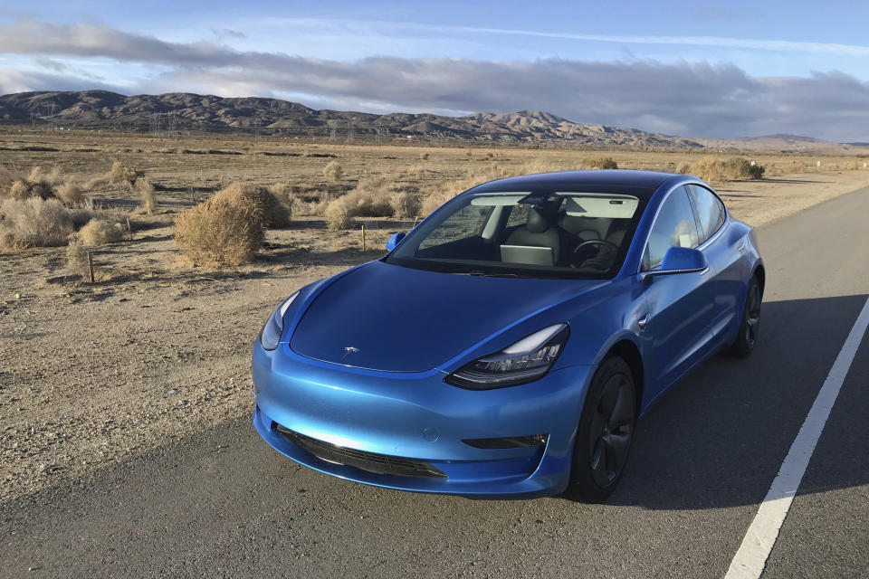 This photo provided by Edmunds shows a 2017 Tesla Model 3 fitted with an aftermarket vinyl wrap. Wrapping your vehicle gives it a fresh and distinctive look. (Courtesy of Edmunds via AP)