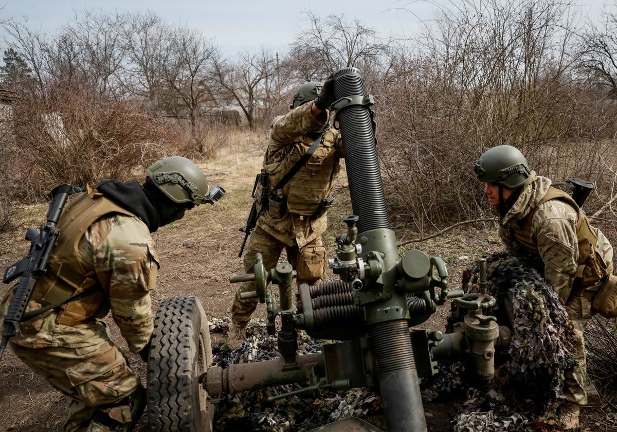 Service members with the Freedom of Russia Legion under the Ukrainian Army prepare to fire a mortar at a Russian military position (REUTERS)