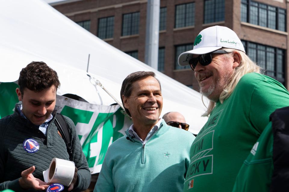 Brad Chambers, middle, an Indiana Republican gubernatorial candidate, talks to Denver Gray, right, during the Indianapolis Firefighters Emerald Society’s St. Paddy’s Day Tent Party on Friday, March 15, 2024, in Indianapolis.