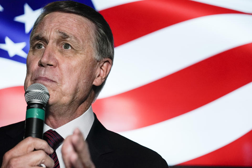 FILE - In this Friday, Nov. 13, 2020 file photo, candidate for U.S. Senate Sen. David Perdue speaks during a campaign rally, in Cumming, Ga. Perdue is hoping years spent as one of Donald Trump's biggest defenders pays off in Georgia, a state the president lost in last month's election. Perdue and Georgia's other senator, Republican Kelly Loeffler, are both campaigning for Jan. 5 runoff elections that will decide control of the Senate. (AP Photo/Brynn Anderson, File)