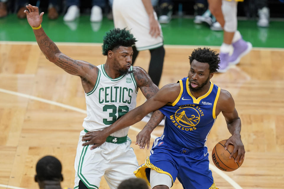 Golden State Warriors forward Andrew Wiggins (22) drives against Boston Celtics guard Marcus Smart (36) during the first quarter of Game 6 of basketball's NBA Finals, Thursday, June 16, 2022, in Boston. (AP Photo/Steven Senne)