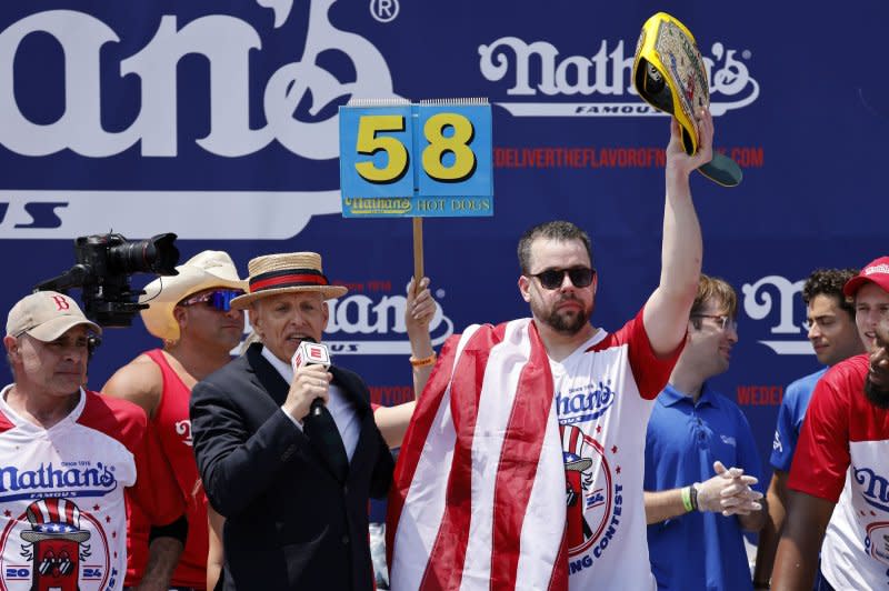 Patrick Bertoletti holds up the championship belt after being declared the winner of the 108th Nathan's Hot Dog Eating Contest in Coney Island, Brooklyn, N.Y., Photo by Peter Foley/UPI