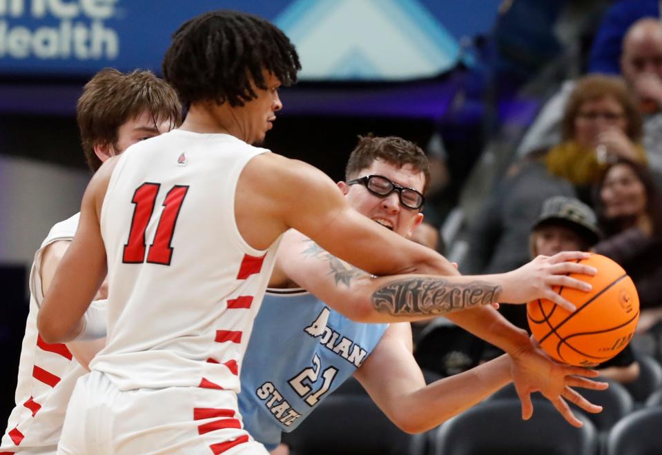 Ball State Cardinals forward Basheer Jihad (11) fouls Indiana State Sycamores center Robbie Avila (21) during the NCAA men’s basketball game, Saturday, Dec. 16, 2023, at Gainbridge Fieldhouse in Indianapolis. Indiana State Sycamores won 83-72.