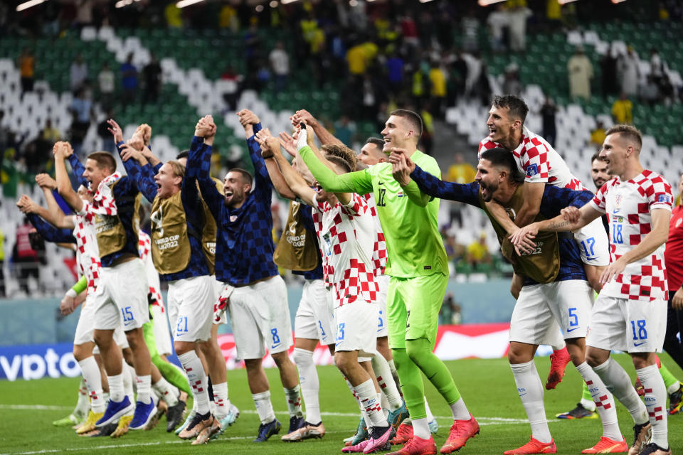 Players of Croatia's celebrate defeating Brazil in a penalty shootout during a World Cup quarterfinal soccer match at the Education City Stadium in Al Rayyan, Qatar, Friday, Dec. 9, 2022. (AP Photo/Manu Fernandez)