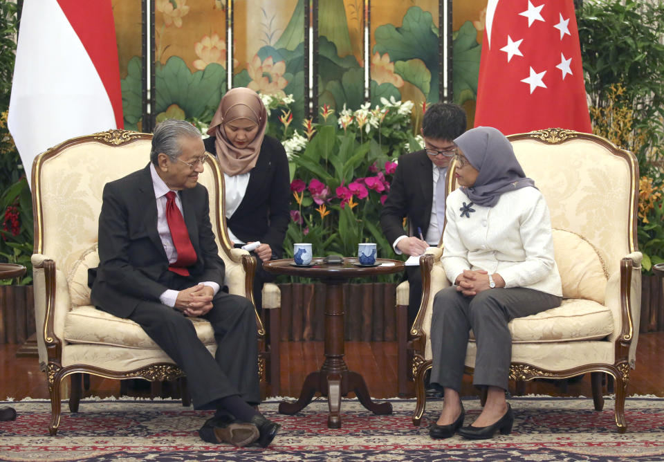 Malaysia's Prime Minister Mahathir Mohamad, left, meets with Singapore's President Halimah Yacob at the Istana in SingaporeMonday, Nov. 12, 2018. (Feline Lim/Pool Photo via AP)