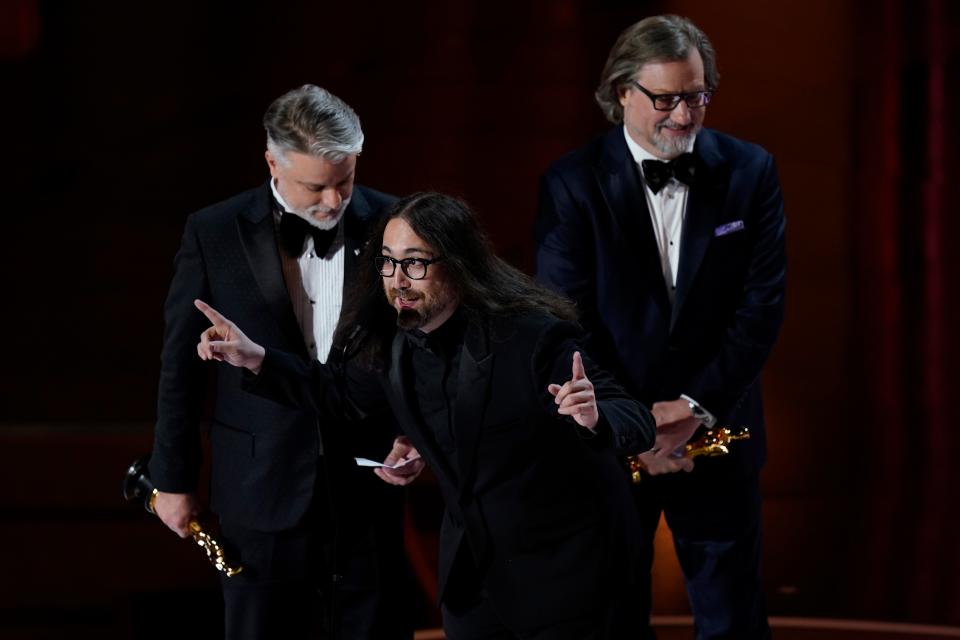 Brad Booker, from left, Sean Ono Lennon and Dave Mullins accept the award for best animated short film for "WAR IS OVER! Inspired by the Music of John & Yoko" during the 2024 Oscars on March 10, 2024.