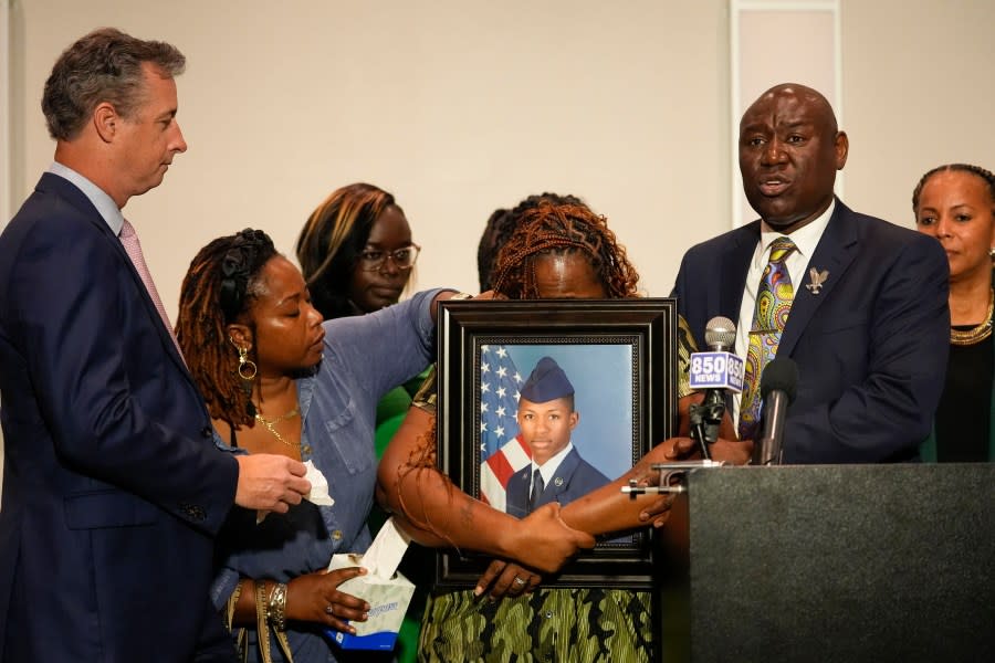 CORRECTS SERVICE BRANCH TO U.S. AIR FORCE INSTEAD OF U.S. NAVY – Chantemekki Fortson, mother of Roger Fortson, a U.S. Air Force senior airman, weeps as she holds a photo of her son during a news conference regarding his death, along with family and attorney Ben Crump, right, and Brian Bar, left, Thursday, May 9, 2024, in Fort Walton Beach, Fla. Fortson was shot and killed by police in his apartment, May 3, 2024. (AP Photo/Gerald Herbert)