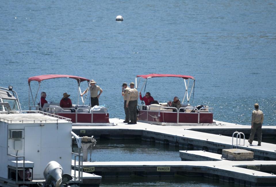 Members of the Ventura County Sheriff's Office are seen at a boating dock in Lake Piru on Monday (AP)