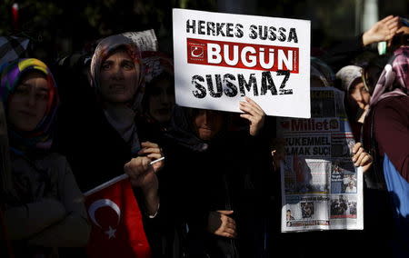 Supporters of Gulen movement hold a placard that reads, "Even if everybody remains silent, Bugun doesn't" during a protest outside the Kanalturk and Bugun TV building in Istanbul, Turkey, October 28, 2015. REUTERS/Murad Sezer