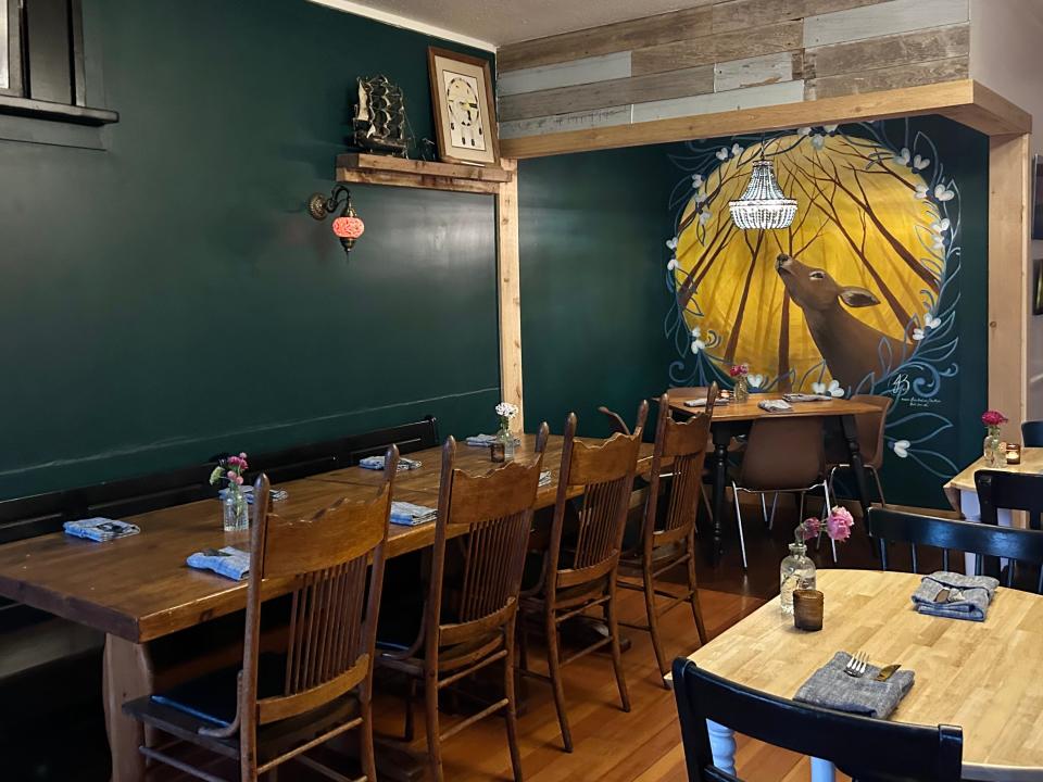 Miijim's cozy interior features a warm, teal-colored accent wall, plus a mural painted by indigenous artist Jess Bear Bland.