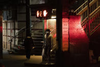 A man walks out of a subway station in the Queens borough of New York, Thursday night, April 23, 2020, during the coronavirus pandemic. The New York City immortalized in song and scene has been swapped out for the last few months with the virus version. In all the unknowing of what the future holds, there's faith in that other quintessential facet of New York City: that the city will adapt. (AP Photo/Mark Lennihan)