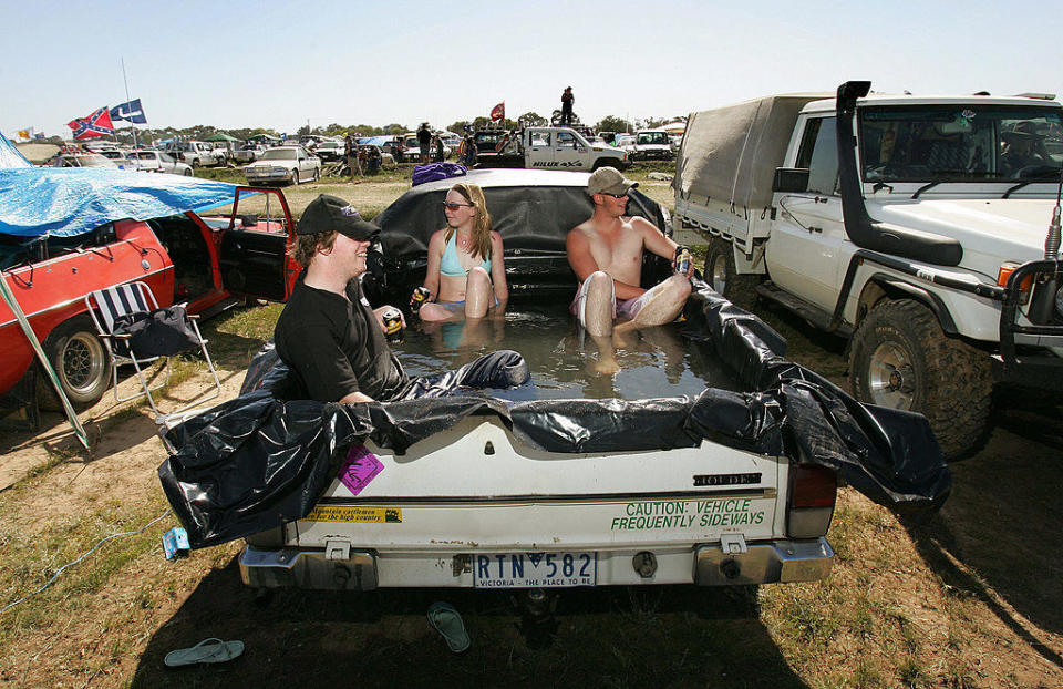 people sit in a pool in a pick up truck.