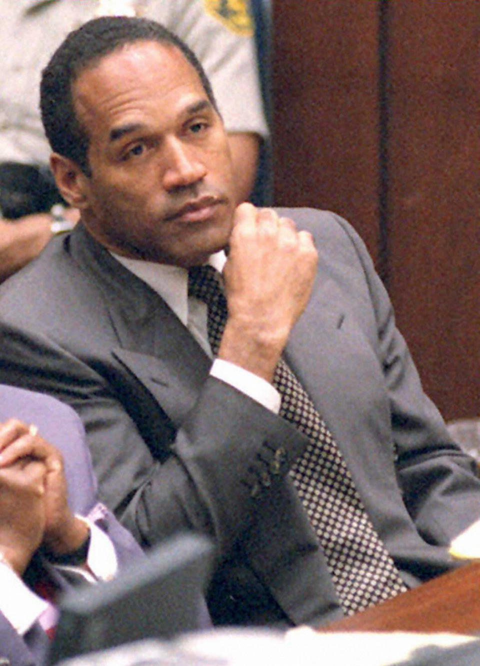 Former American football star and actor O.J. Simpson listens to testimony during his double murder trial in Los Angeles, March 16, 1995. Simpson is on trial for the homicide of his ex-wife Nicole Brown Simpson and her friend Ron Goldman. In this image he listens to the testimony of Lieutenant Philip Vannatter, one of the two lead detectives on the case. - Credit: Dan Mircobich/AFP/Getty Images