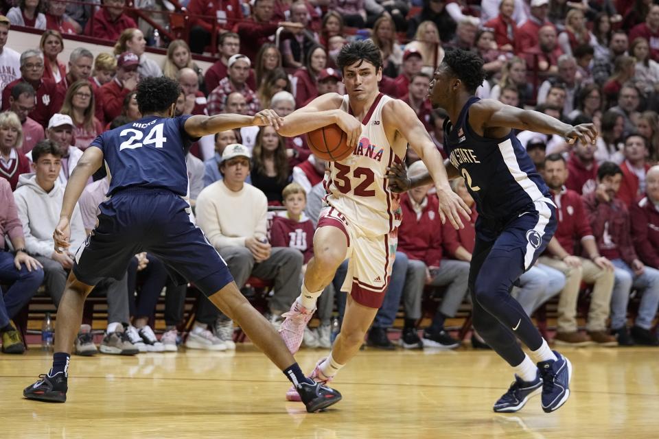 Indiana's Trey Galloway (32) goes to the basket against Penn State's Zach Hicks (24) and D'Marco Dunn (2) during the second half of an NCAA college basketball game, Saturday, Feb. 3, 2024, in Bloomington, Ind. (AP Photo/Darron Cummings)