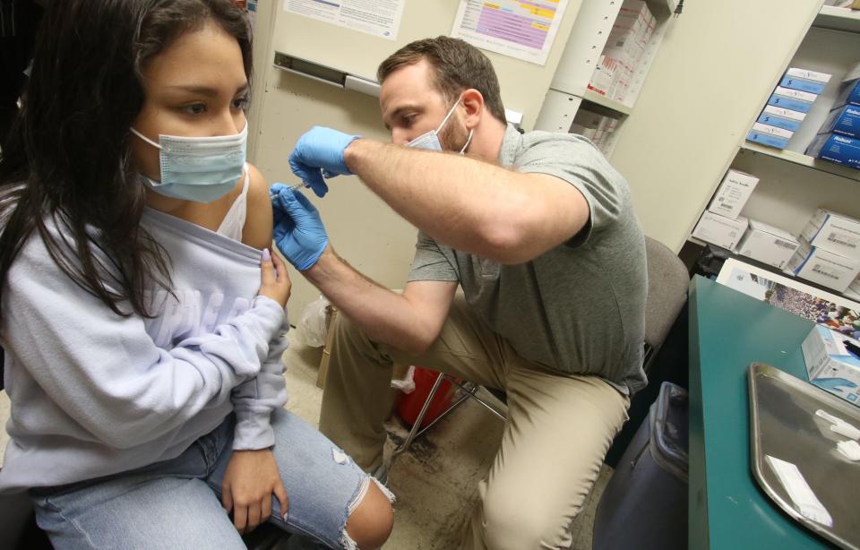 Graham Sprinkles gives the COVID-19 vaccine to Jacquelin Hernandez, 13, Monday afternoon, July 19, 2021, at Medical Center Pharmacy on Cox Road.