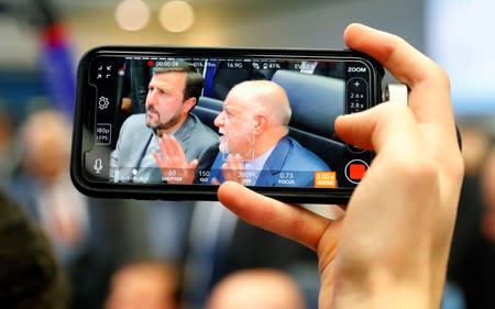 A journalist takes a picture of Iran's Oil Minister Zanganeh at the beginning of an OPEC meeting in Vienna