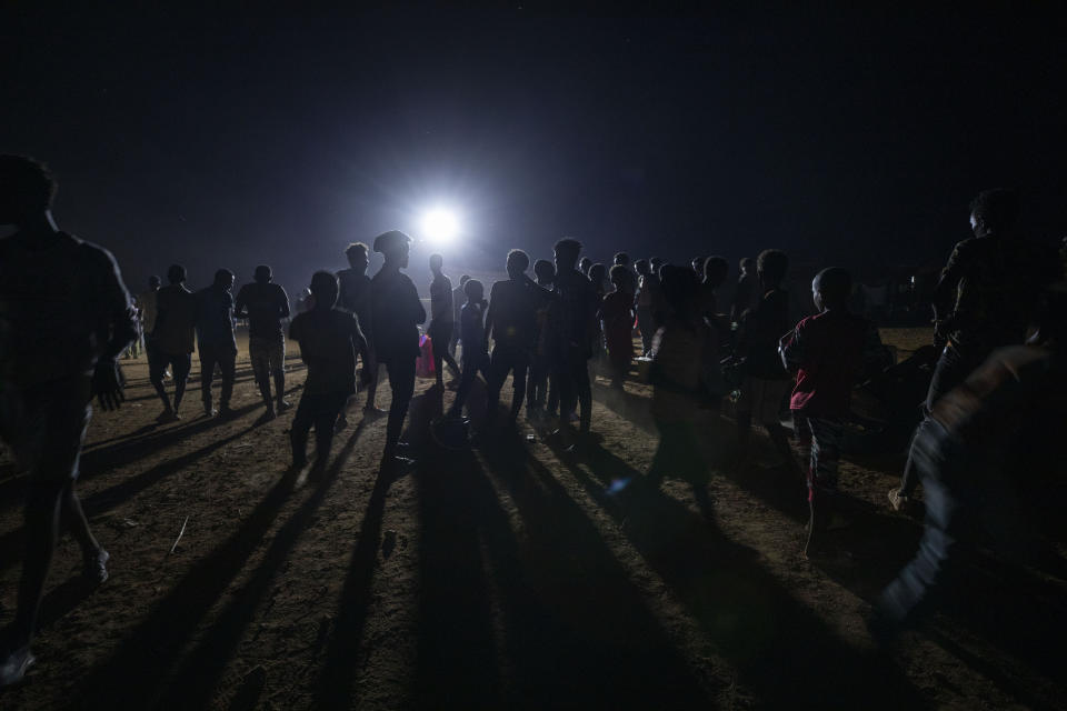 FILE - In this Dec. 4, 2020, file photo, refugees who fled the conflict in Ethiopia's Tigray region gather at Umm Rakouba refugee camp in Qadarif, eastern Sudan. Huge unknowns persist in the deadly conflict, but details of the involvement of neighboring Eritrea, one of the world's most secretive countries, are emerging through witness accounts by survivors and others. (AP Photo/Nariman El-Mofty, File)