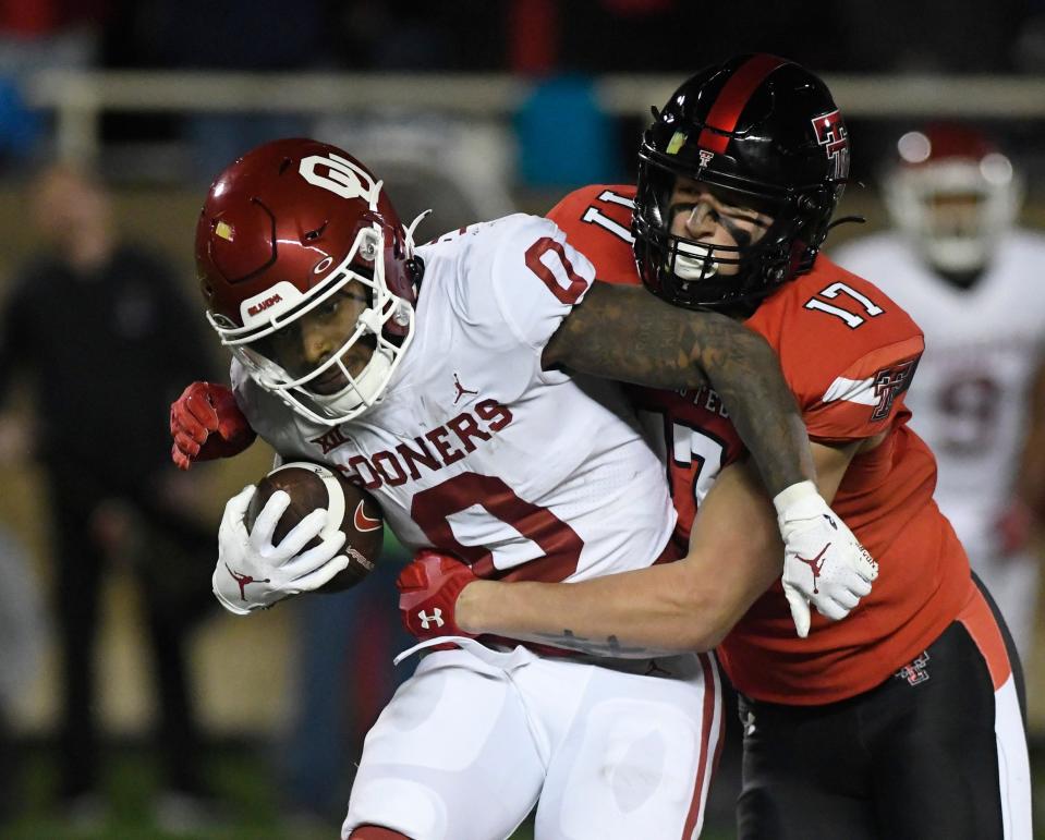 Texas Tech defensive end Isaac Smith (17) wraps up Oklahoma running back Eric Gray (0) during the Red Raiders' 2022 regular-season finale. Smith, one of the Red Raiders' promising young players, will miss the 2023 season with a knee injury, a source told The Avalanche-Journal on Saturday.