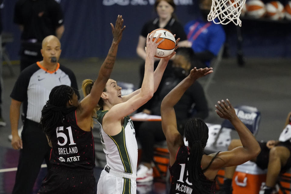 Seattle Storm's Breanna Stewart, second from left, shoots against Indiana Fever's Jessica Breland (51) and Teaira McCowan (15) during the first half of a WNBA basketball game, Thursday, June 17, 2021, in Indianapolis. (AP Photo/Darron Cummings)