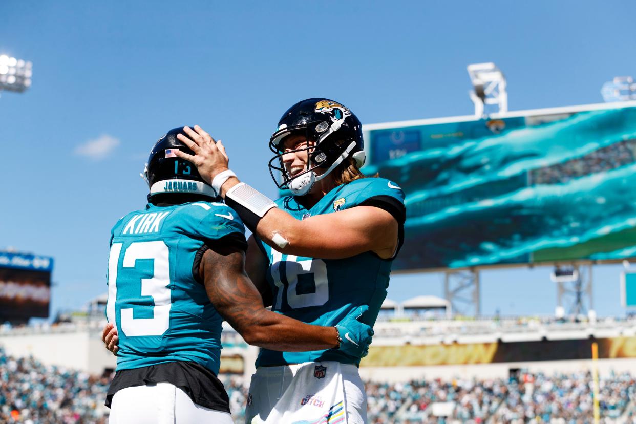 Oct 15, 2023; Jacksonville, Florida, USA; Jacksonville Jaguars quarterback Trevor Lawrence (16) and wide receiver Christian Kirk (13) celebrate a touchdown against the Indianapolis Colts during the second quarter at EverBank Stadium. Mandatory Credit: Morgan Tencza-USA TODAY Sports