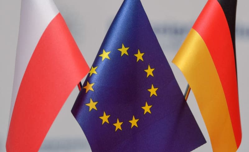 Small flags from Poland, the EU and Germany are placed a table at the Border Conference 2019 of the Brandenburg Police Headquarters and the Polish Police. Polish Foreign Minister Radoslaw Sikorski urged Germany to make proposals on how to make reparation for the damage Poland suffered during World War II in a keynote speech to parliament in Warsaw on 25 April. Patrick Pleul/dpa-Zentralbild/dpa