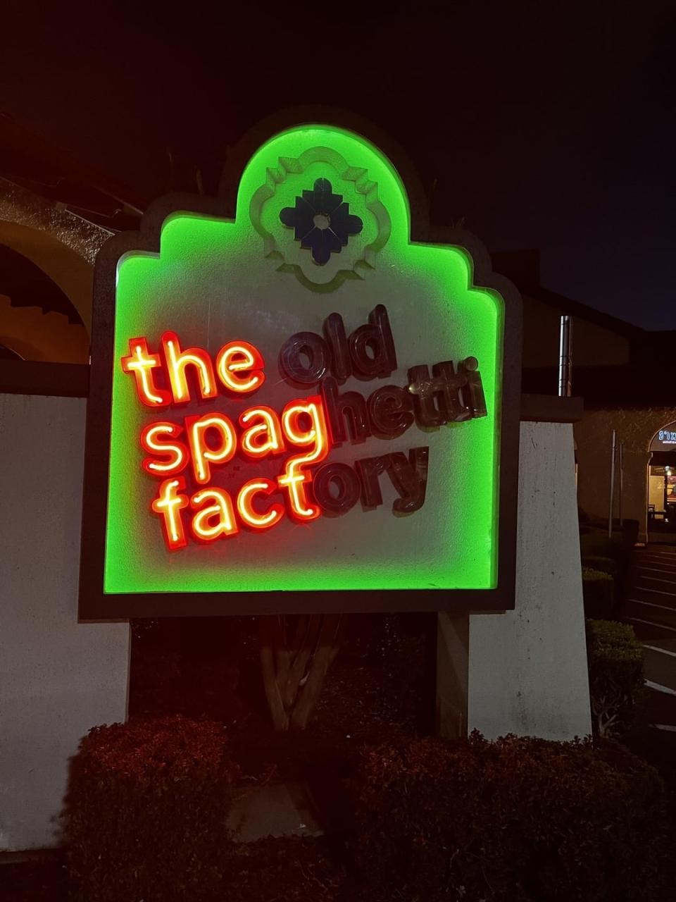 Neon sign of "The Old Spaghetti Factory" partially burnt out to read "the spag fact"