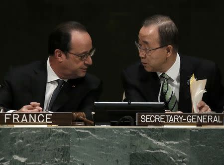 Ban Ki-moon (R), Secretary-General of the United Nations, chats with French President Francois Hollande before delivering his opening remarks at the Paris Agreement signing ceremony on climate change held at the United Nations Headquarters in Manhattan, New York, U.S., April 22, 2016. REUTERS/Mike Segar