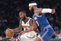 Denver Nuggets guard Will Barton (5) drives to the basket as New York Knicks center Mitchell Robinson (13) defends during the first half of an NBA basketball game Thursday, Dec. 5, 2019, at Madison Square Garden in New York. (AP Photo/Mary Altaffer)