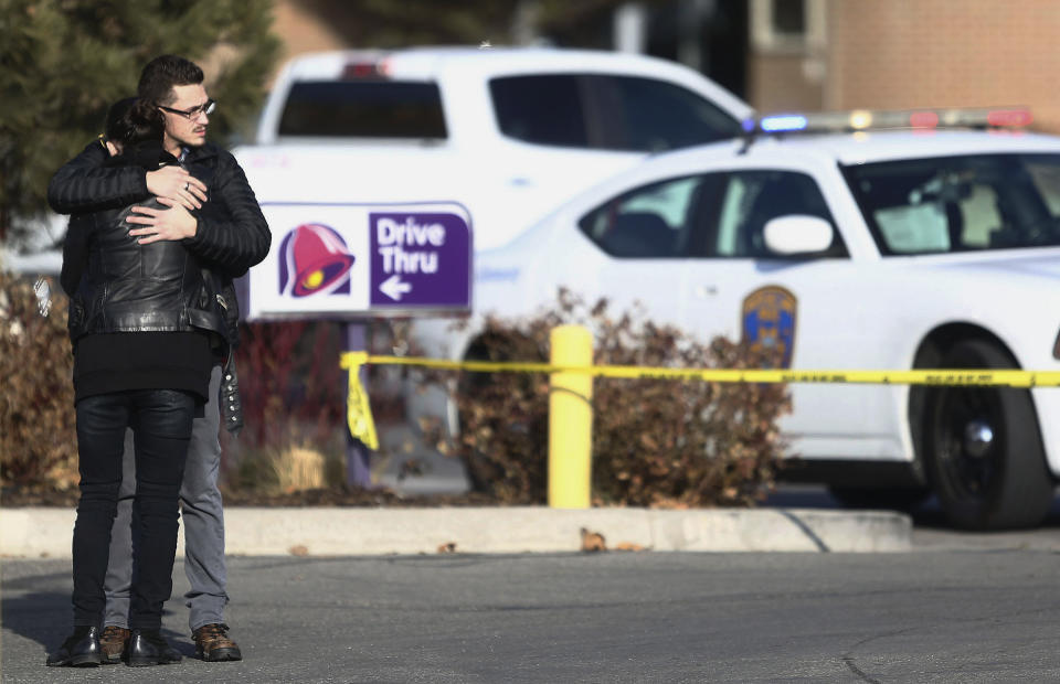 A man and woman embrace as police investigate a shooting at the Fashion Place mall in Murray, Utah, Sunday, Jan. 13, 2019. (Silas Walker/The Deseret News via AP)