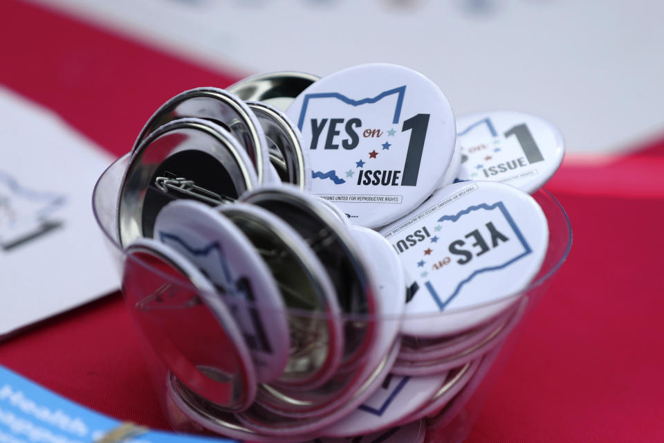 FILE - Buttons in support of Issue 1, the Right to Reproductive Freedom amendment, sit on display at a rally held by Ohioans United for Reproductive Rights at the Ohio Statehouse in Columbus, Ohio, Sunday, Oct. 8, 2023. Heavier-than-normal turnout is expected Wednesday, Oct. 11, 2023, as early voting begins in Ohio's closely watched off-year election to decide the future of abortion access and marijuana legalization in the state. (AP Photo/Joe Maiorana, File)