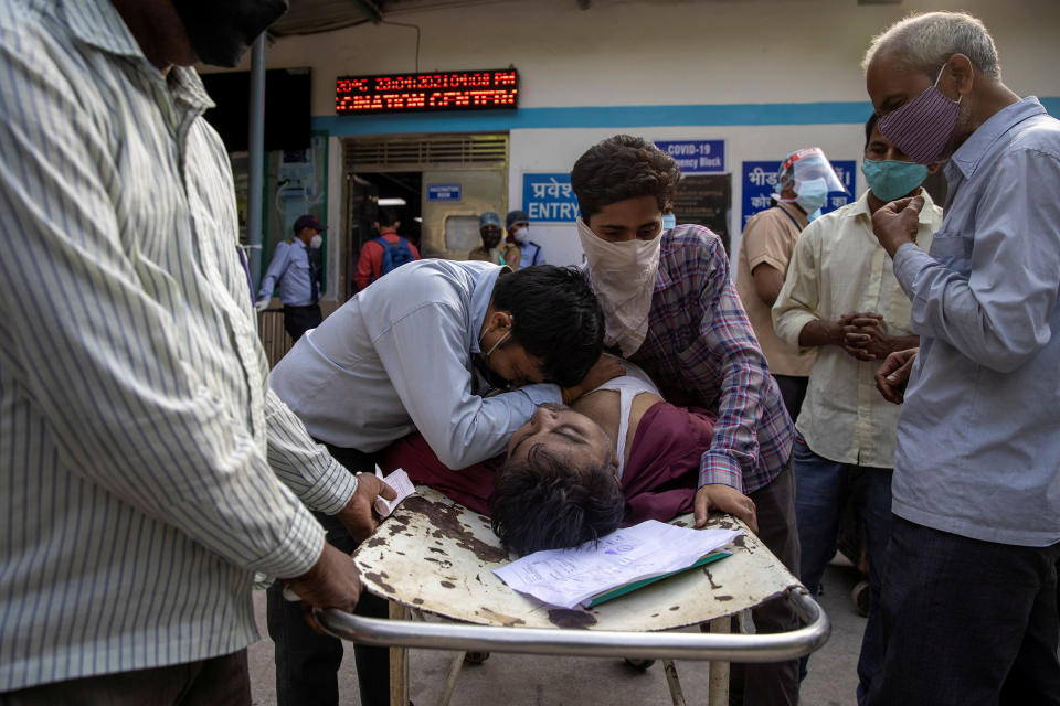 Family members mourn after Shayam Narayan, a 45-year-old COVID-19 patient and father of five, is declared dead outside the COVID-19 casualty ward at Guru Teg Bahadur Hospital in Delhi on April 23.<span class="copyright">Danish Siddiqui—Reuters</span>