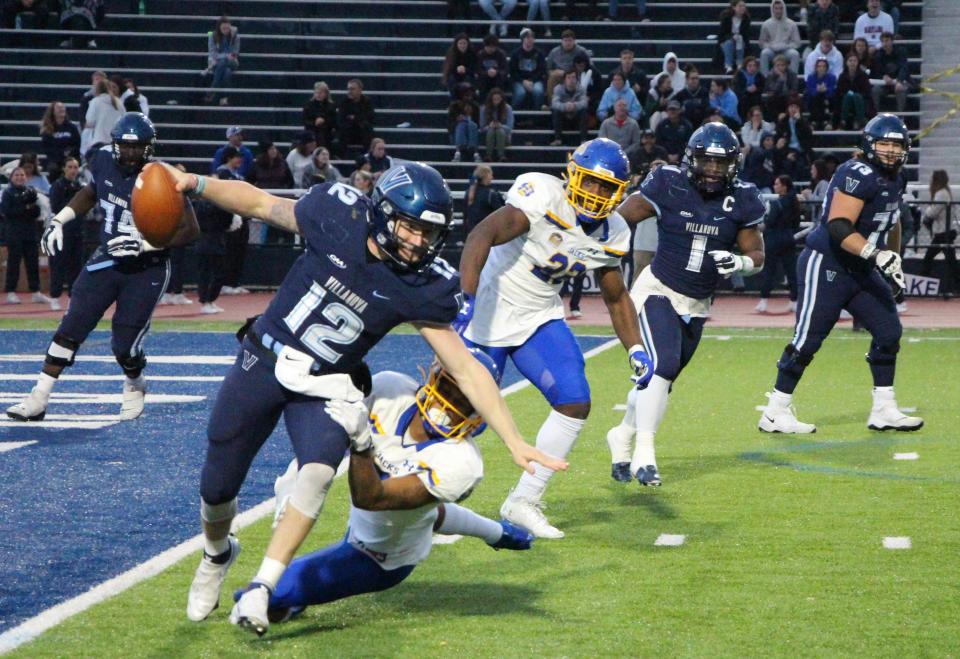 Villanova QB Dan Smith is pulled down by SDSU's Dalys Beanum