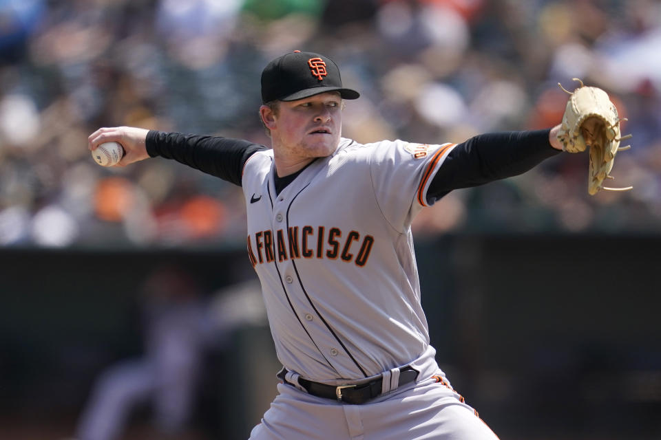 San Francisco Giants' Logan Webb pitches against the Oakland Athletics during the first inning of a baseball game in Oakland, Calif., Sunday, Aug. 22, 2021. (AP Photo/Jeff Chiu)