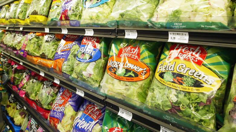 Grocery store display of bagged greens