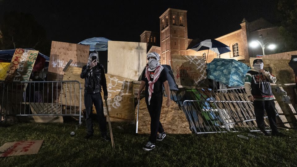 Pro-Palestinian demonstrators regroup and rebuild the barricade surrounding the encampment set up on the UCLA campus on May 1, 2024. - Etienne Laurent/AFP/Getty Images