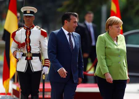 Macedonian Prime Minister Zoran Zaev and German Chancellor Angela Merkel attend a welcome ceremony in Skopje, Macedonia September 8, 2018. REUTERS/Ognen Teofilovski