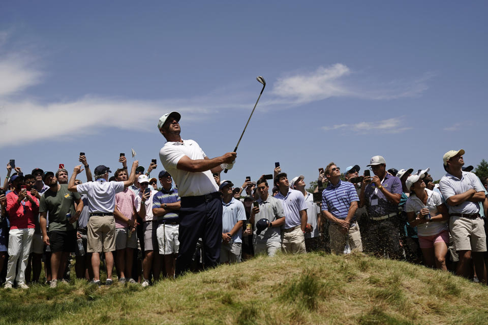 Brooks Koepka watches his shot on the 17th hole during the second round of the U.S. Open golf tournament at The Country Club, Friday, June 17, 2022, in Brookline, Mass. (AP Photo/Charlie Riedel)