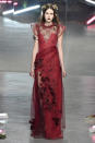 Rodarte’s lady in red lace and floral appliqué. (Photo by Catwalking/Getty Images)