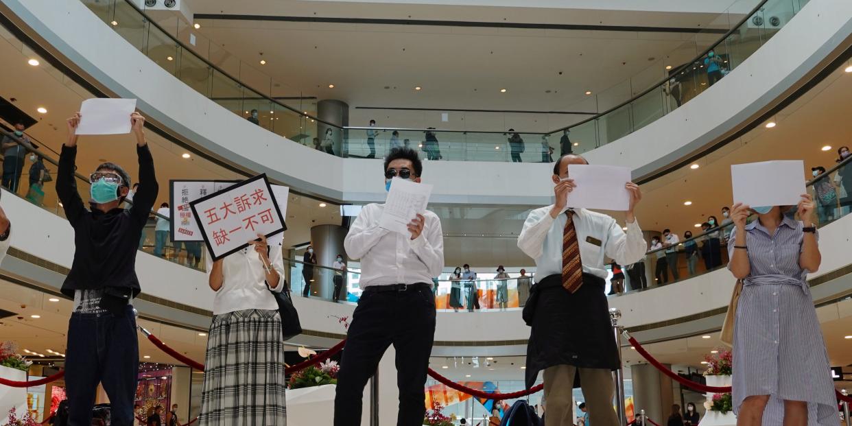 Pro-democracy demonstrators take part in a lunchtime protest against the national security law, at a shopping mall in Hong Kong, China July 6, 2020. REUTERS/Joyce Zhou