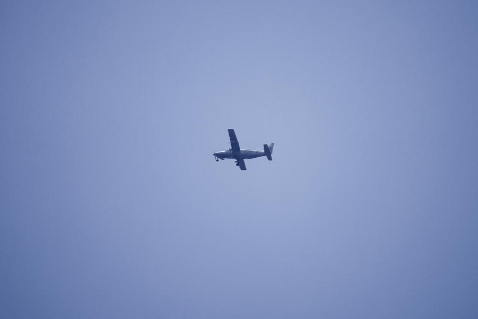 A Lebanese Army's Cessna airplane flies over the U.S. Embassy in Aukar, a northern suburb of Beirut, Lebanon, Wednesday, June 5, 2024. A gunman was captured by Lebanese soldiers after attempting to attack the U.S. Embassy near Beirut on Wednesday, the military said. (AP Photo/Hassan Ammar)